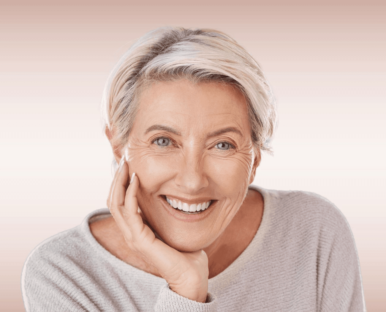 Elegant older woman smiling confidently with implant-supported dentures at Esthetique Dentistry Ashburn