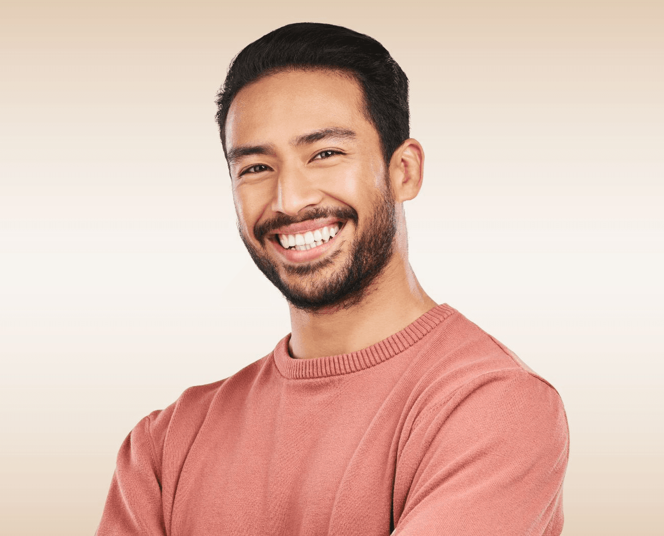Young man with beard smiling confidently after preventive dental care at Esthetique Dentistry Ashburn